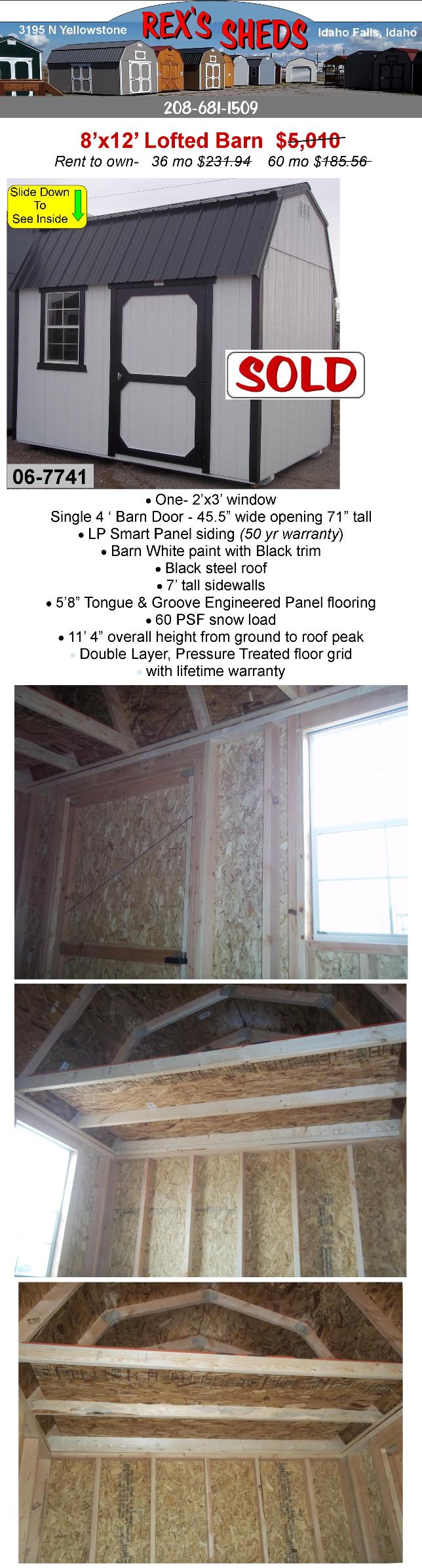 barn_style_shed_with_overhead_loft_at_front_and_rear_barn_white_paint_black_trim_a_window_next_to_barn_door_and_black_steel_roof